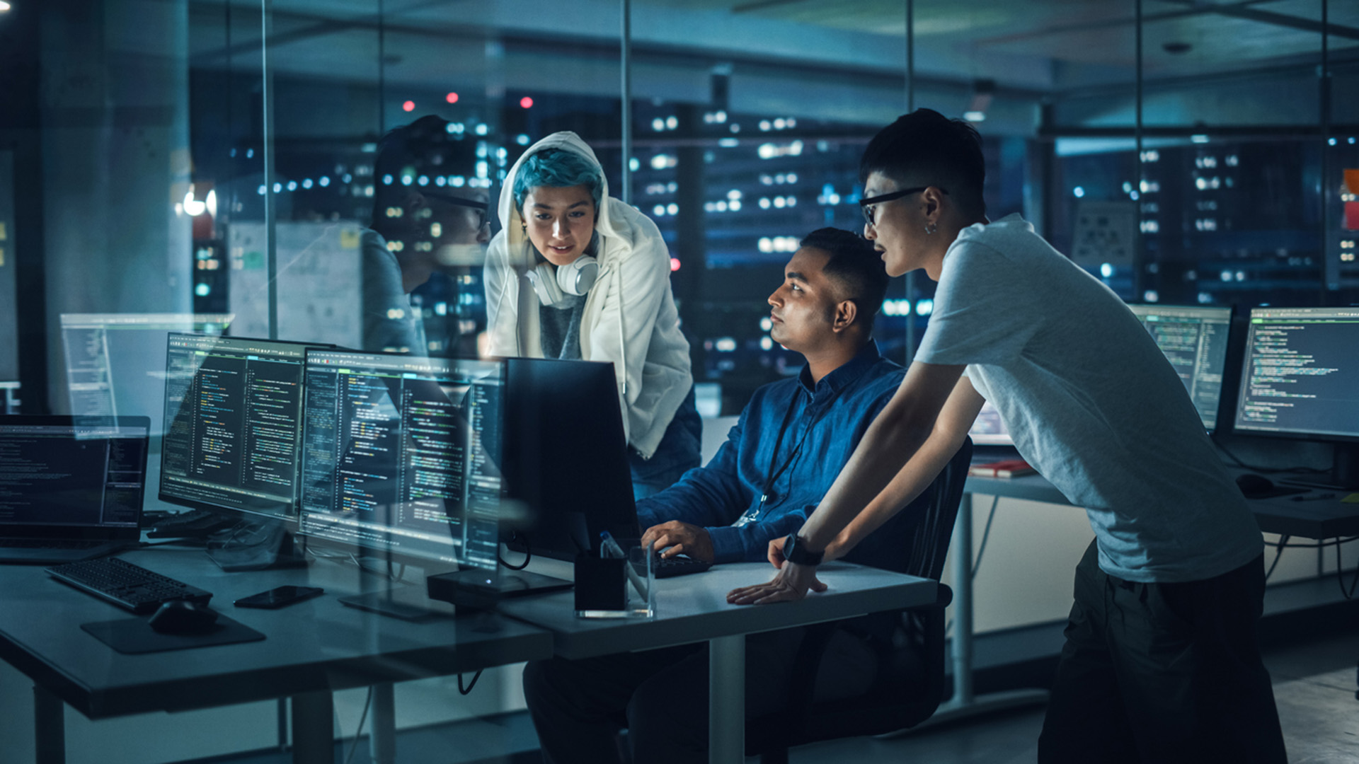 Cybersecurity team looking over a laptop