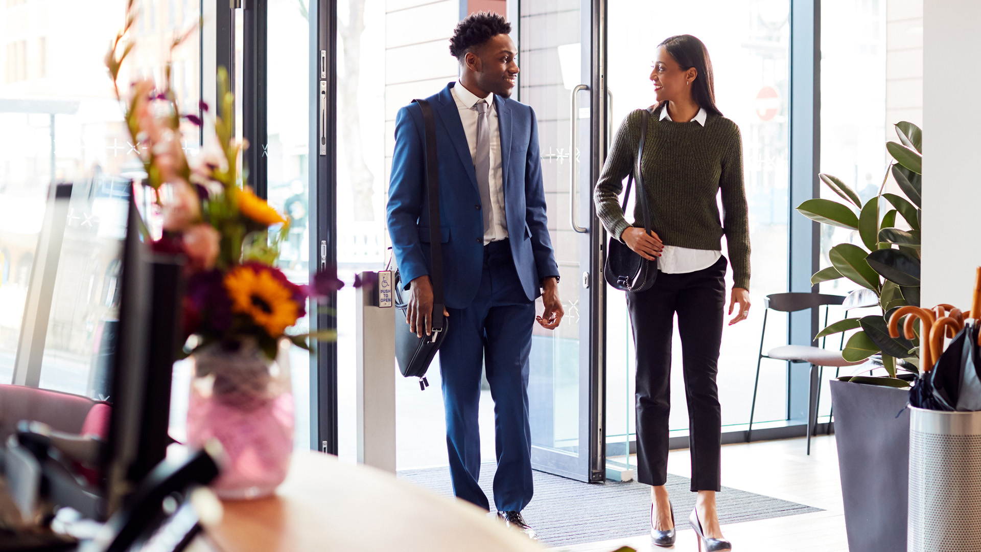 Employees walking into business lobby