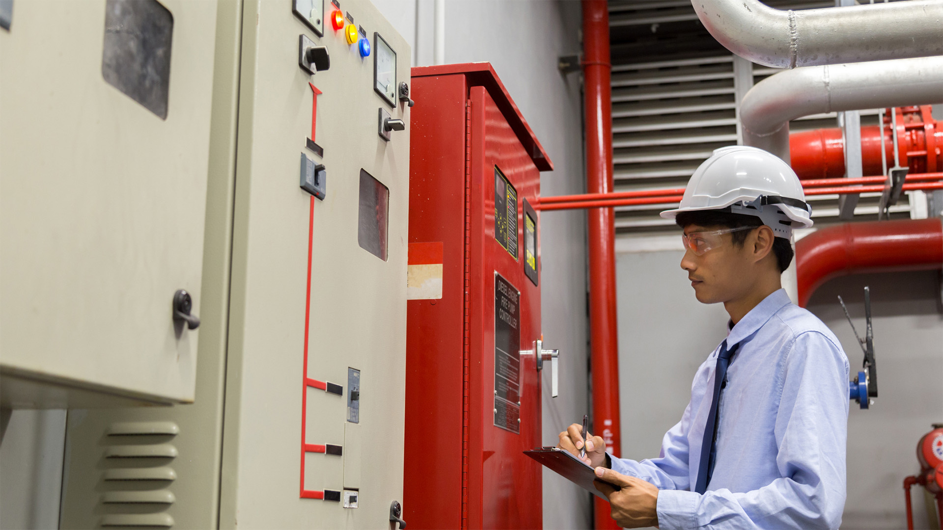 Man inspecting fire alarm system