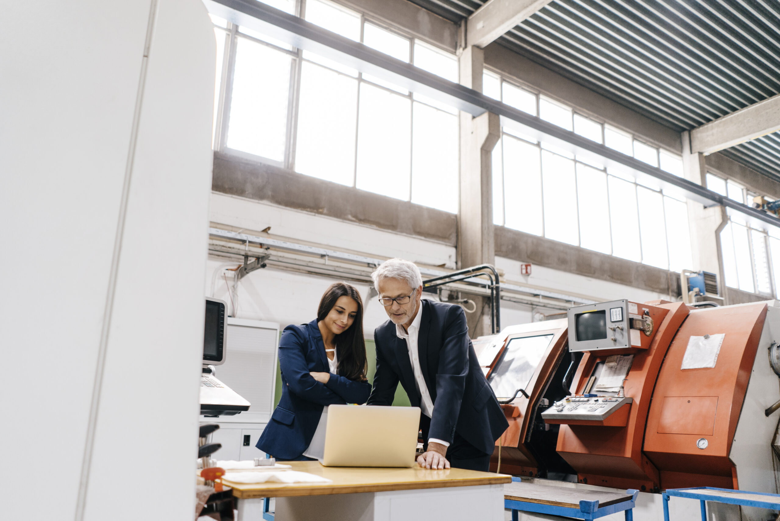Business man and business woman discussing business security over a laptop
