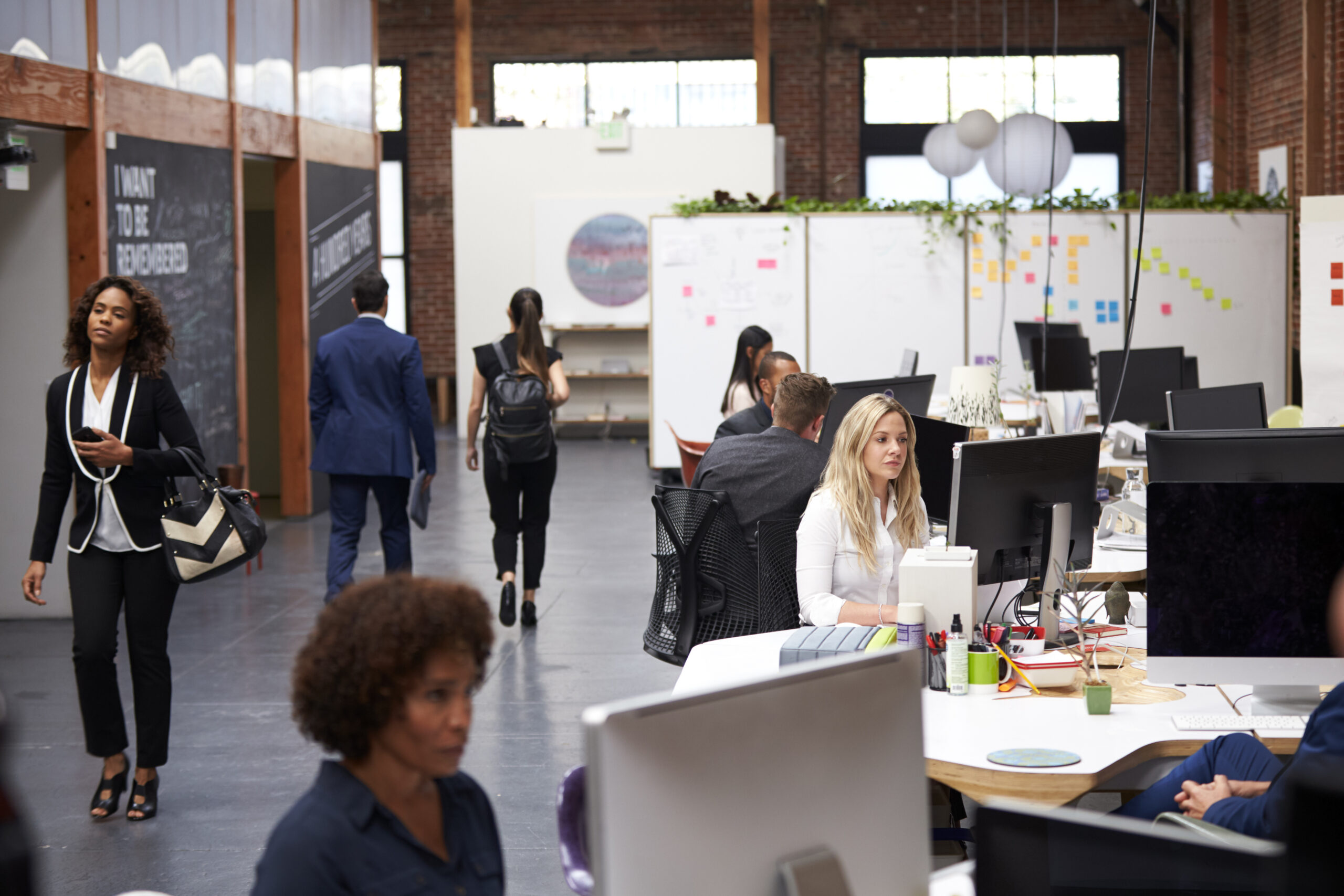 Business Security Team Working At Desks In Modern Open Plan Office