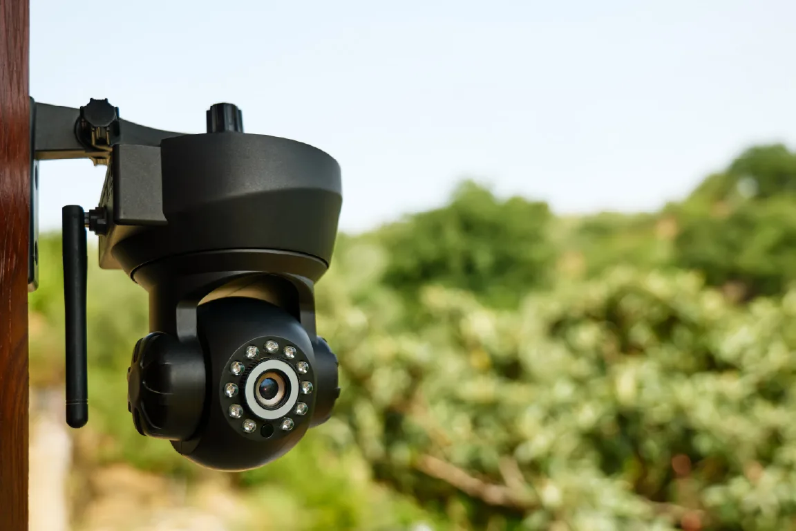 Outdoor security camera monitoring agricultural equipment on a farm.