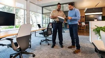 Two people reviewing plans in an office