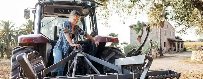 A woman on a tractor farm